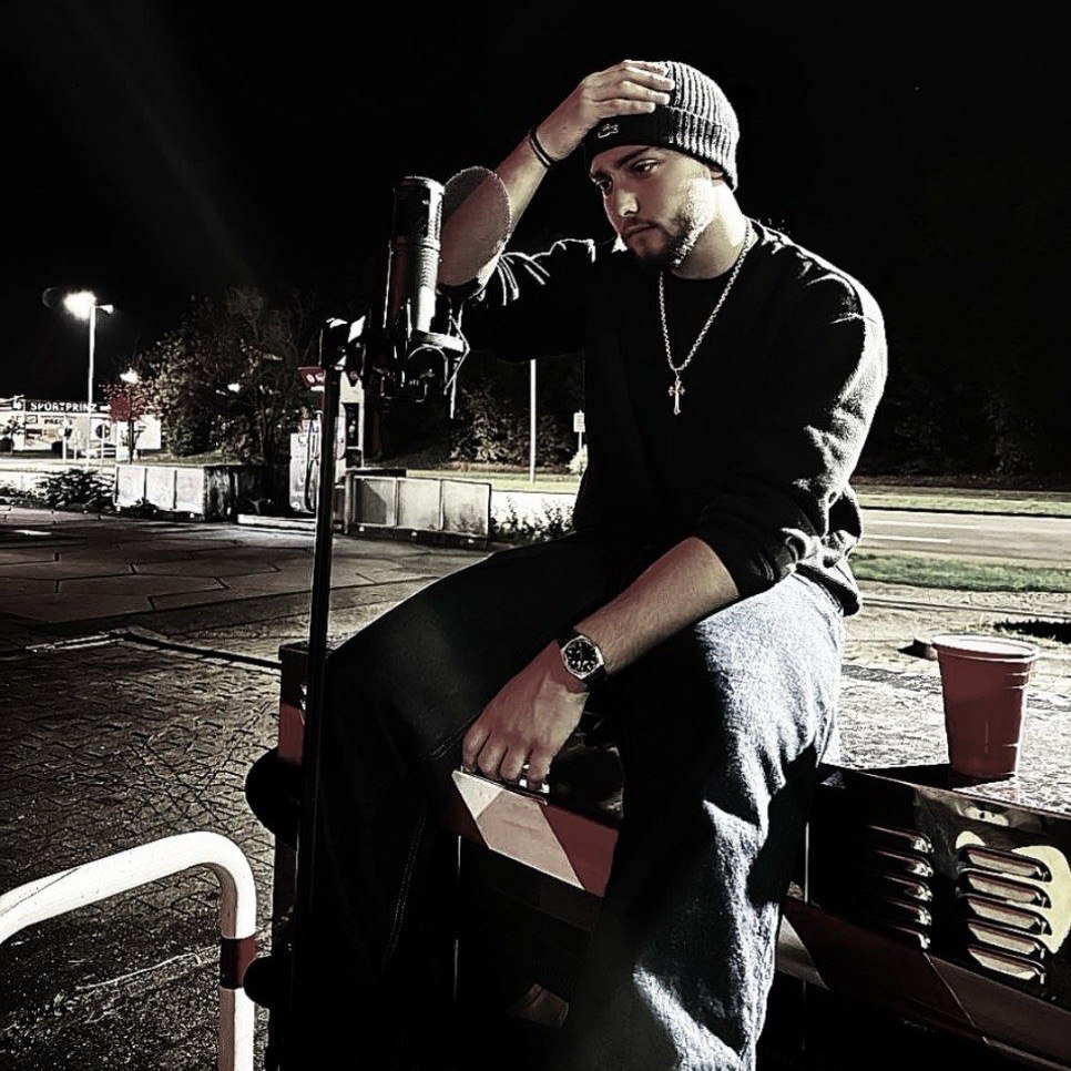 Miketheyoungin at a microphone at night